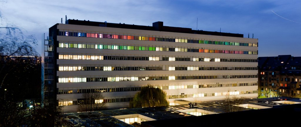  Vue nocturne du b&acirc;timent du BLSI, dont les fen&ecirc;tres &eacute;clair&eacute;es et color&eacute;es se d&eacute;tachent dans le paysage urbain